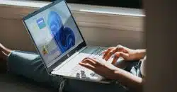 person using Windows 11 computer on lap